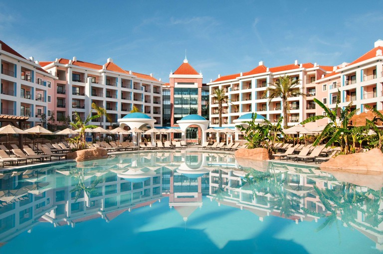Outdoor pool and sun-loungers at Hilton Vilamoura As Cascatas Golf Resort & Spa.