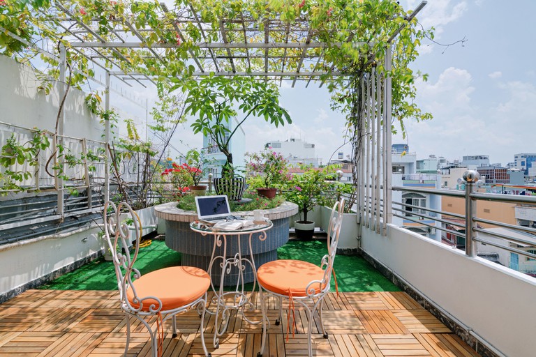 Romantic rooftop terrace and garden with spectacular views of the city at Chez Mimosa boutique hotel in Ho Chi Minh City, Vietnam