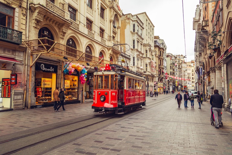 Nostalgic red retro tram on famous Istiklal street. ISTANBUL, TURKEY - NOVEMBER 13, 2018.