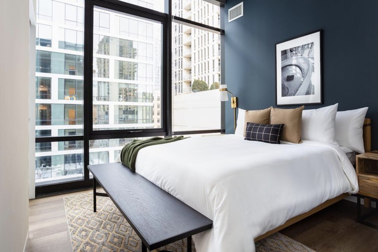 A contemporary bedroom with floor-to-ceiling windows at Sonder at South Wabash.