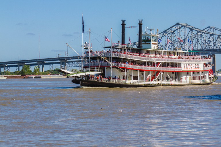 Natchez steamboat, New Orleans, Louisiana, United States. Steamboat on Mississippi River with bridge in background.