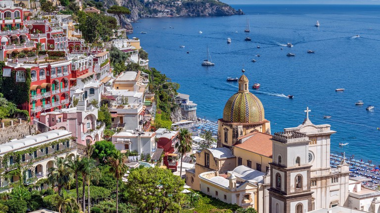 Looking down on Positano with its colourful homes and church dome, Italy