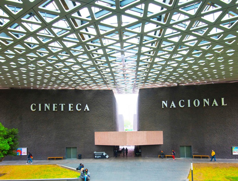 Film-goers gather under the tall, latticed roof of Cineteca Nacional