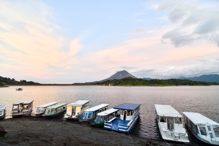 2D6WB26 fishing boats on the lake, Arenal Volcano lake park in Costa rica central america