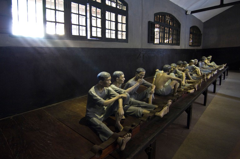 Horizontal view of an exhibit inside Hoa Lo Prison Museum aka Hanoi Hilton of prisoners in shackles in central Hanoi, Vietnam. Image shot 2011. Exact date unknown.