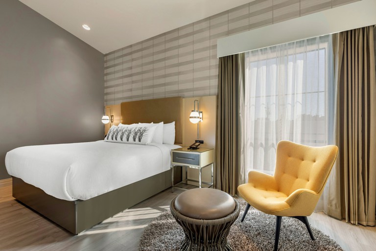 Retro-chic bedroom with wood floors at Bluestem Hotel Torrance-Los Angeles, Ascend Hotel Collection