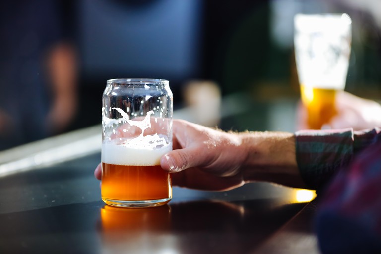 A Man Enjoying A Craft Beer At A Brew Pub
