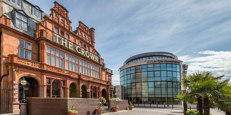 An outside view of Clayton Crown Hotel, with its glass exterior