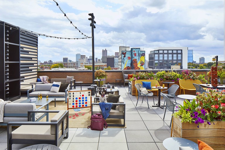 Roof terrace at the Moxy Columbus Short North with connect four game and colourful seats looking out over the city