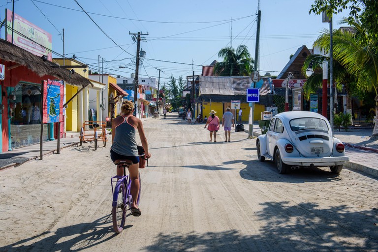 Tourists in a street of Isla Holbox, Quintana Roo (Mexico).