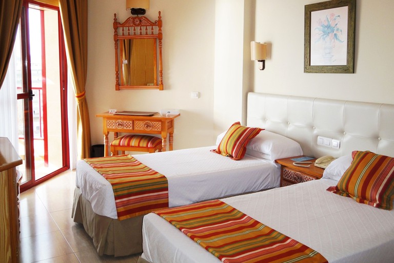 A double room in Hotel Angela, decked in colours of orange and white