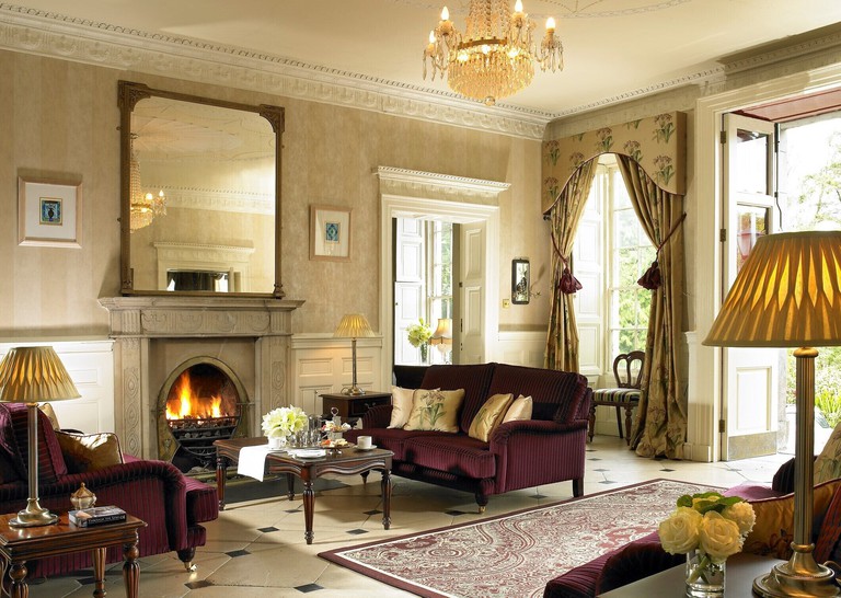 A traditional seating space at the Clayton Hotel Cork City with a golden chandelier dangling from the ceiling