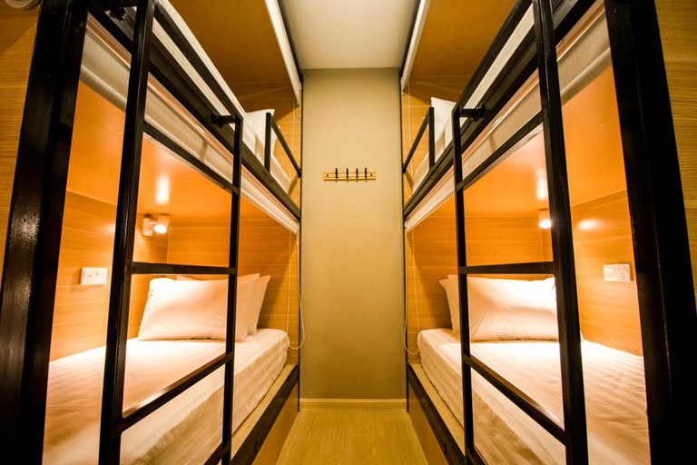 Two bunk beds in a well-lit Hexa Hotel room