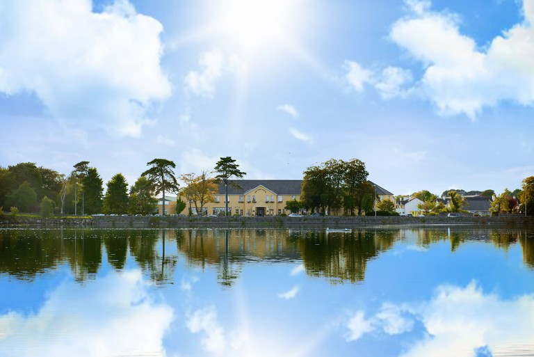 The manor-like Park Hotel is reflected in the waters of Colligan River