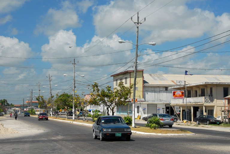 A car drives down a road in Corozal, Corozal District, Belize, Central America