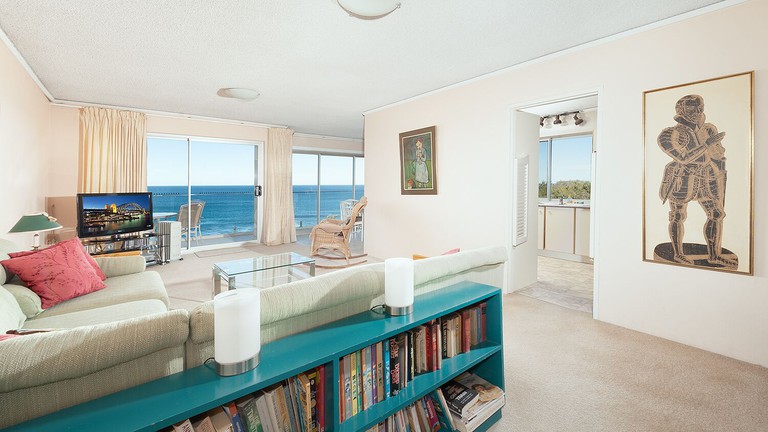 Absolute Water Front Coogee's light-filled living space with artwork and ocean views