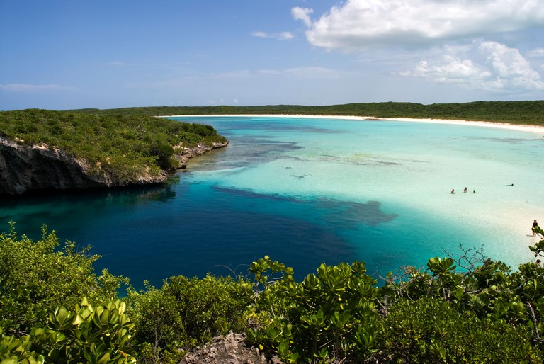 Swimmers in the multicoloured waters of Dean's Blue Hole, Long Island, Bahamas