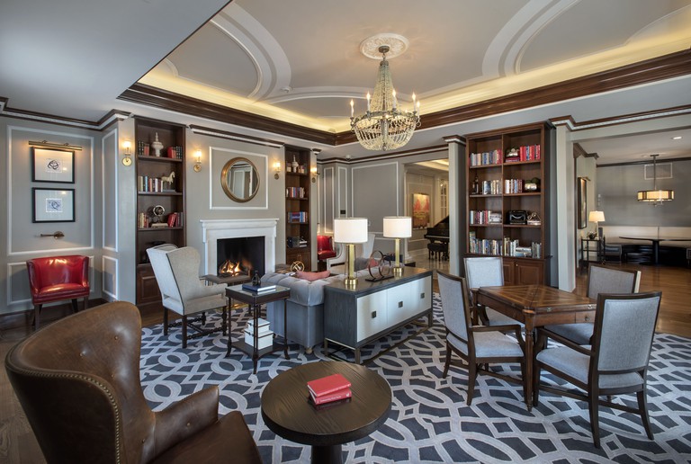 Room at the Chancellor's House, with bookshelves and elegant decor in shades of grey and dark brown