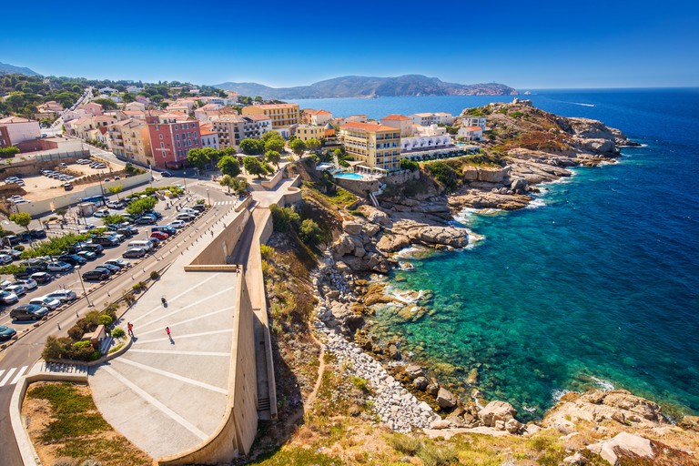 An aerial view of the beautiful Corsica coastline and historic houses in Calvi