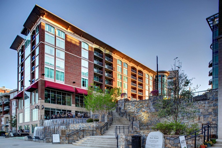 The exterior of Hampton Inn & Suites Greenville-Downtown-RiverPlace, with a stone stairway leading upwards