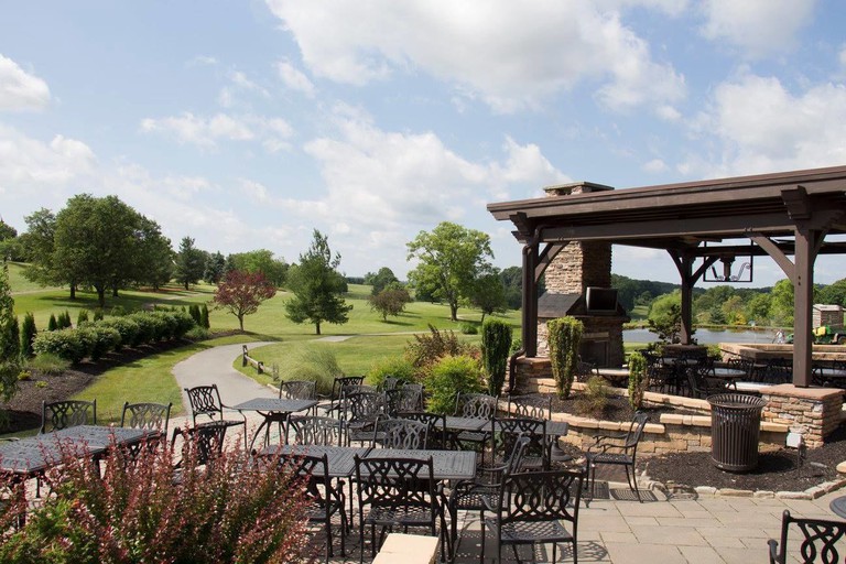 The Avenue Ale House and Pizza Loft outdoor seating overlooking the golf course at the Heritage Hills Resort