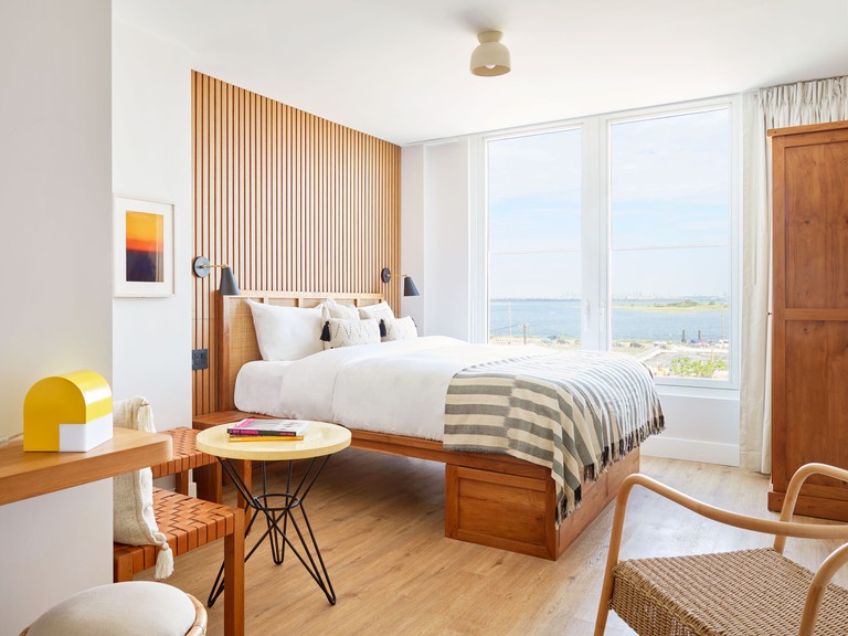 Bright and stylish guest room with views out to the water at the Rockaway Hotel