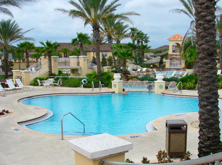 Villas at Regal Palms swimming pool with water slide on an overcast day Davenport, Florida
