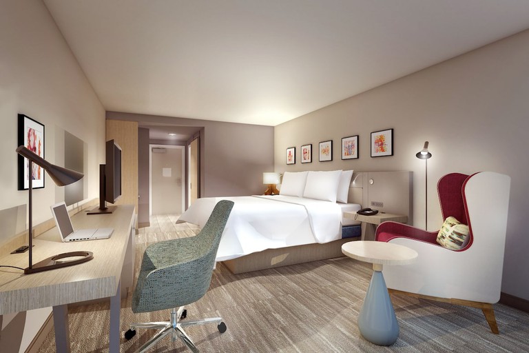 A modern room with a bed, desk and television at Hilton Garden Inn Fremont Milpitas