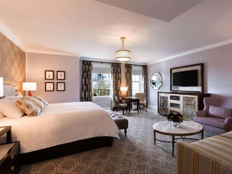 A double bed, seating and a television in a room at The Claremont Club & Spa