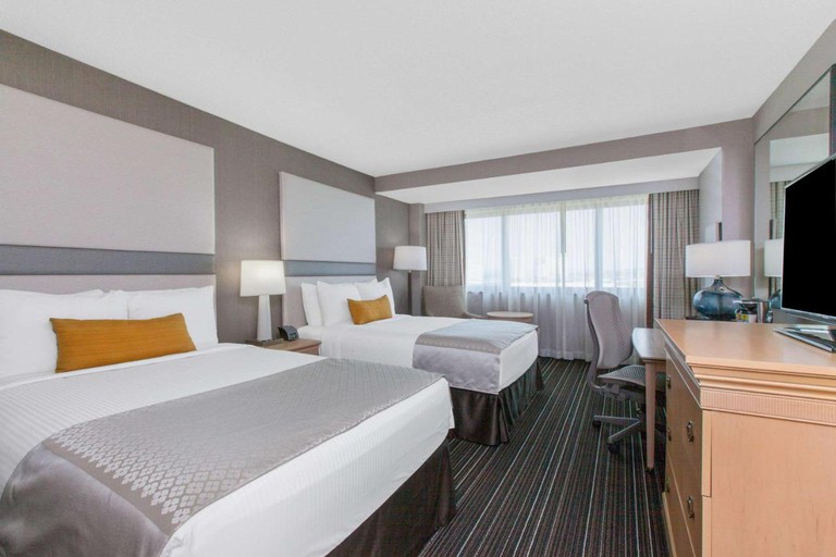 Comfy room with two large beds, desk and ergonomic chair at Sonesta Irvine