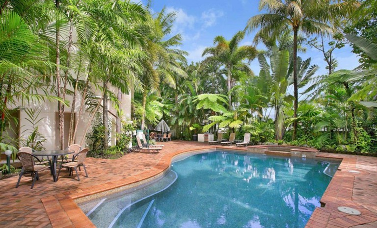 Pool area with lots of plantlife at Tropic Towers Apartments, Cairns