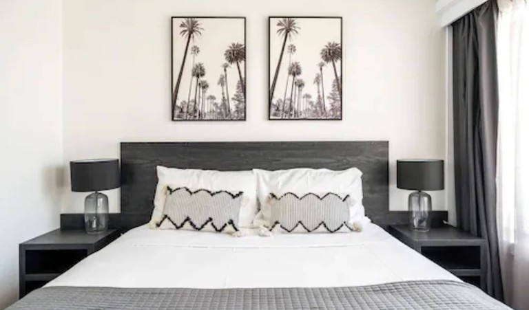 Room at Motel 617 Kiama motel in Kiama, Australia has modern design, patterned pillows and grey tones