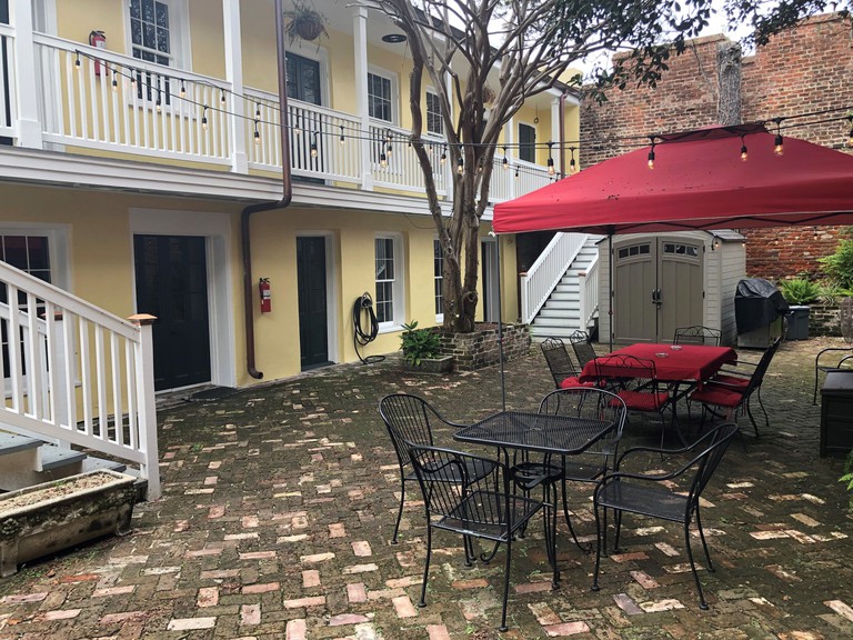 Courtyard at the Haunted Hotel New Orleans with tables and stairs