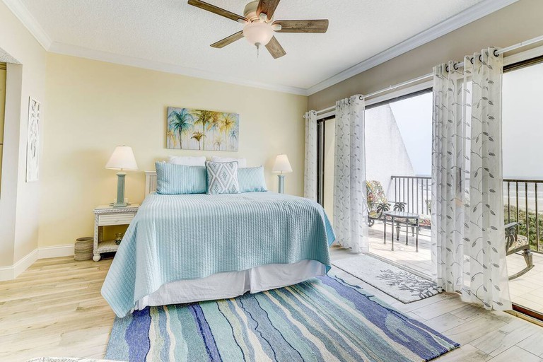 Breezy bedroom with balcony and sea views at Ocean Sunrise 505