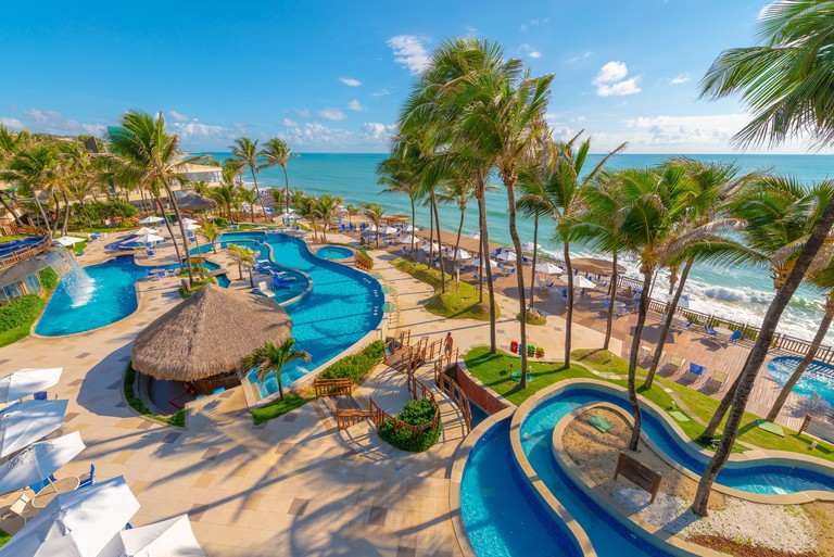 Overhead view of oceanfront tropical lagoon-style pools with fountain at Ocean Palace Beach Resort and Bungalows