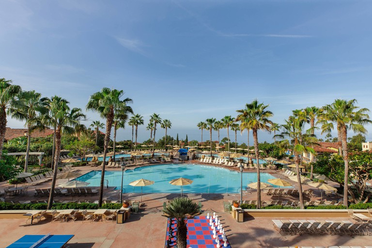 Marriott’s Newport Coast Villas' large multi-pool area with palm trees and lounge chairs