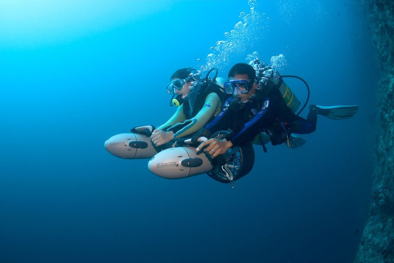 Two divers with an Underwater Scooter