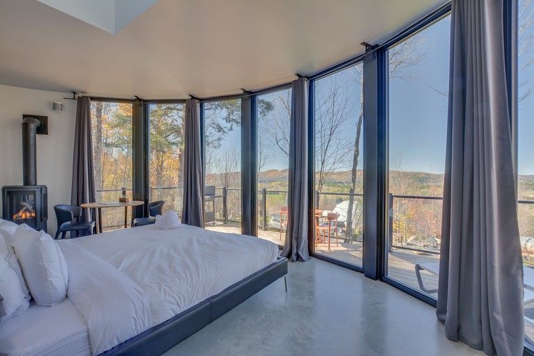 A double room with fireplace, enormous windows and a balcony at the Bel Air Tremblant