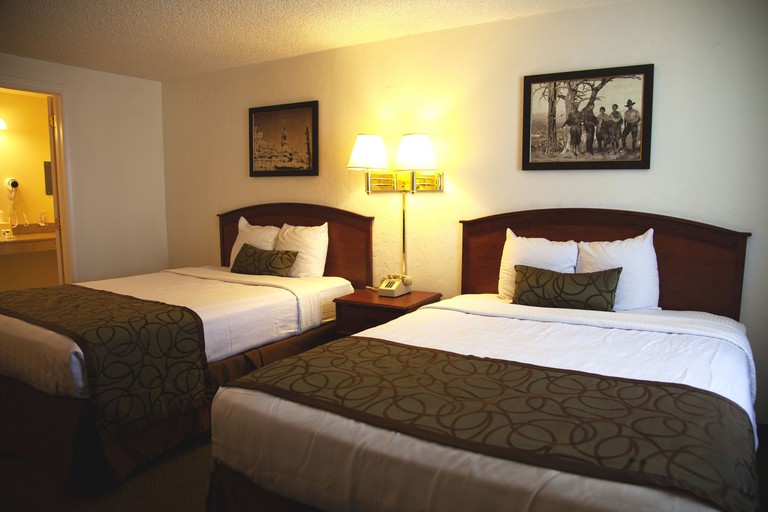 A comfortable guest room with two queen-size beds and black-and-white photography at the Bryce View Lodge