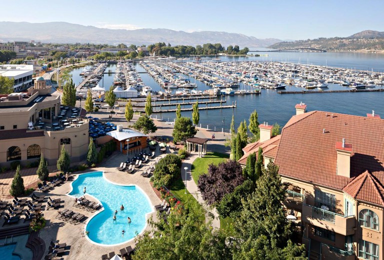 Aerial view of Delta Hotels by Marriott Grand Okanagan Resort and Lake Okanagan behind it