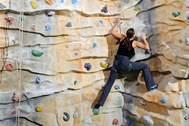 Person tackling an indoor climbing wall