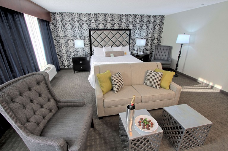 A cozy suite with a separate seating area at the Hilton Garden Inn Westbury