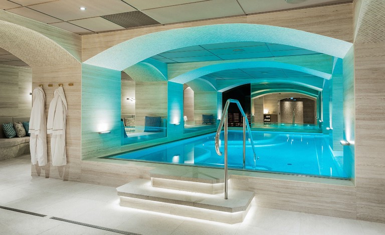Interior pool with robes and sleek surrounds at Hotel Riverton