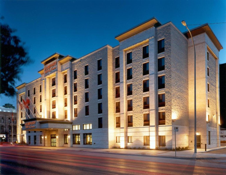 The exterior of the six-story Humphry Inn and Suites at nightfall