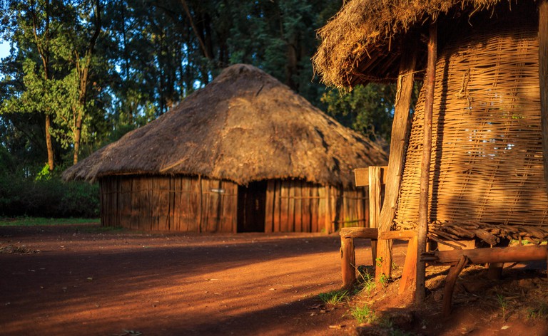 A view of a cone-roofed wooden home in a traditional Kenyan village, Nairobi