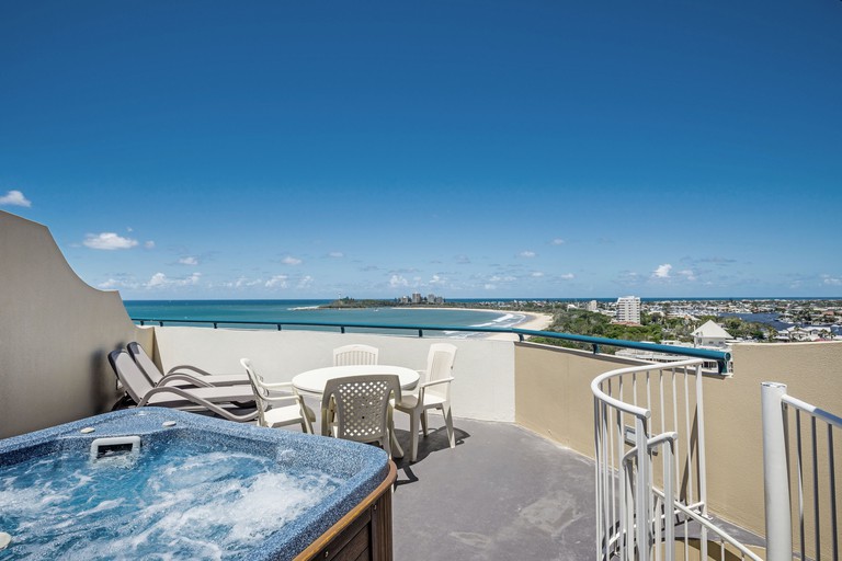 A rooftop terrace with a hot tub, seating and ocean views at the Landmark Resort and Spa