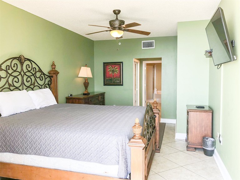 A pistachio-green bedroom at the Majestic Beach Resort T2 – 1606