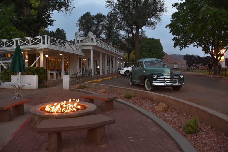 Parry Lodge with vintage cars and fire pit in front, Utah