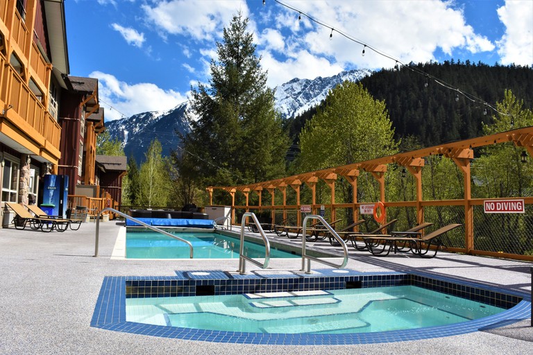 Swimming pool outside of Pemberton Valley Lodge, Pemberton with view of the snow-topped mountains behind