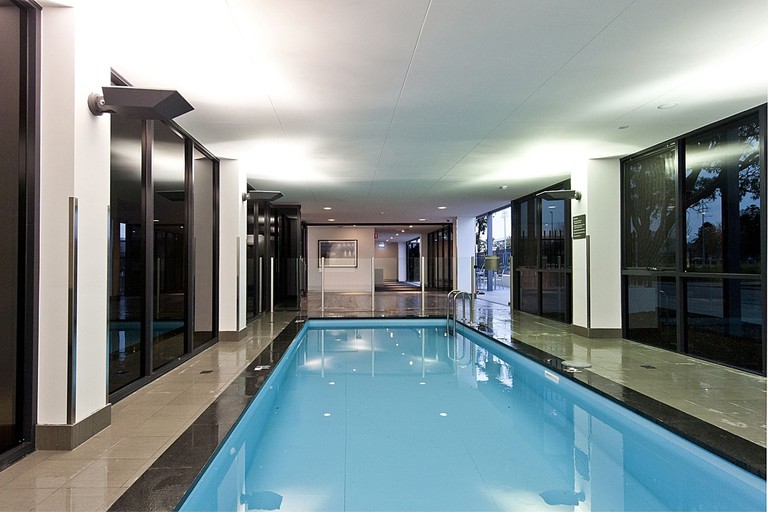 The indoor pool area at Quest Rockingham, with tinted windows